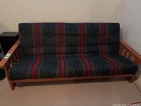 Front view of futon sofa showing entire frame and mattress pattern