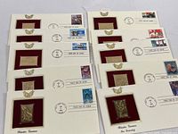Group shot of all eleven gold replica first day covers in lot