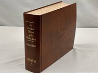 Closed brown album binder, front and spine visible