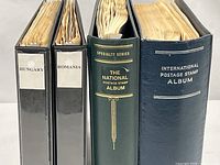 Four binders standing: Hungary, Romania, The National Album, International Album
