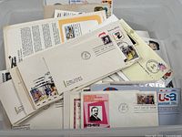 Plastic bin containing large quantity of first day covers on pages and loose
