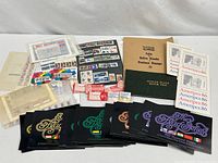 Overview of all stamp items: UN Flag Series folders, Slogan Plate Block file, folio of entire sheets, assorted loose sheets/blocks
