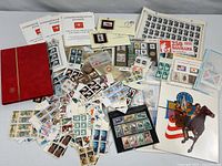 overview of entire stamp lot showing stockbook, brochures, loose stamps, folders