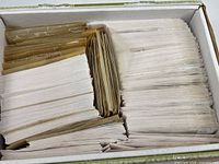 Full box showing numerous glassine envelopes containing stamps