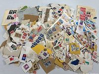 Pile of assorted cancelled stamps on paper