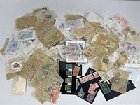 Wide view of entire lot showing numerous glassine sleeves and stock cards filled with stamps