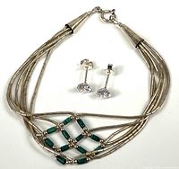 Bracelet laid flat with earrings above showing full design, clasp, beads and earring stones