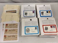 Stacks of display pages with U.S. FDCs plus album pages and bank checks