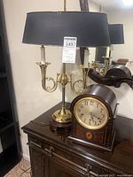Lamp and clock together on table
