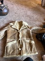 Full view of front of coat on floor