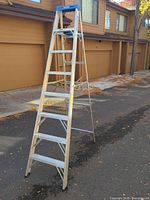 Full view of Werner 8 ft aluminum A-frame ladder extended, showing blue tool tray and overall condition
