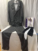 Full costume laid out: jacket, pants, tie