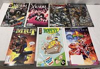 Seven comics laid out front covers visible