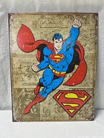 Front view of full metal sign showing Superman artwork and distressed background