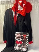 Full view of pajama hung, hood displayed, packaging shown