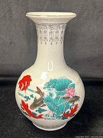 Full view of porcelain vase showing koi and lotus artwork and overall form