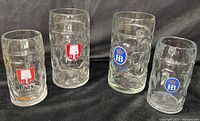 Group image showing all four glass beer steins with Spaten and HB logos