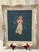 Full view of framed needlepoint artwork