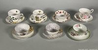All seven teacup and saucer sets displayed