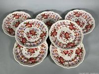 Seven floral plates arranged in overlapping formation