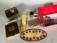 Overview of entire lot showing binder set, quarter display set, coin rolls, envelopes, coin bank, red bin of loose coins