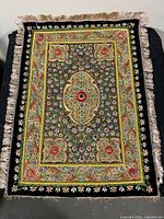 Full view of embroidered silk rug showing size, pattern, and fringe