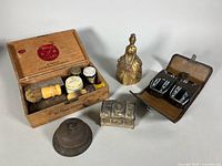 Full lot overview: cigar box, bells, trinket chest, travel shave kit displayed