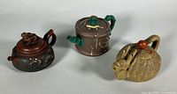 Three Yixing teapots group view