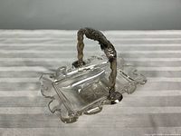 Overall view of crystal basket with sterling handle upright