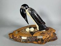 Front angle showing entire loon sculpture, base, eggs and plaques