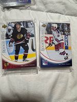 Front view showing sealed card bricks with Adam Burish and Nigel Dawes cards on top