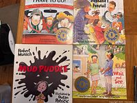 Four Robert Munsch Classic Munsch books laid out: I Have to Go!, Stephanie’s Ponytail, Mud Puddle, Wait and See