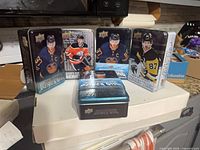 Front view of five Upper Deck collector tins featuring Connor McDavid and Sidney Crosby