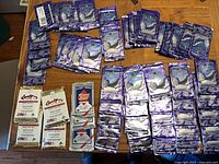 Overview showing numerous purple Casper packs with Country Gold and Looney Tunes packs on table