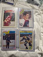All four rookie cards in plastic sleeves