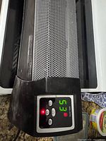 Control panel showing digital display and buttons, visible scuffs