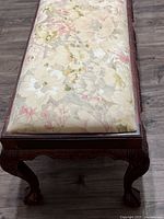 Top view showing floral upholstered seat and carved frame