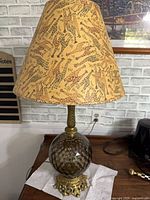 Full view of lamp with giraffe shade on wooden surface