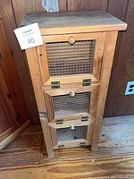Full view of wooden jelly cabinet showing three mesh doors