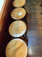Overhead view of all four round wood seats aligned along counter