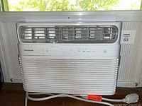 Front view of Frigidaire window air conditioner installed with side panels