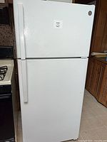 Front view of GE white top-freezer refrigerator