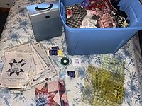 Overview of tote with fabric, file box, book, patterns and some notions