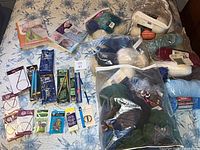 Overview showing books, packaged needles, yarn bags
