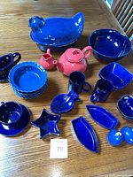 Group shot of all blue and red porcelain pieces laid out on table