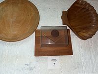 Overview of all three wooden serving items: round platter, cheese tray with lid, shell bowl