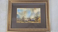 Full view of framed watercolor in gold frame with mats