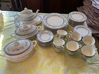 Full dinnerware set laid out on table