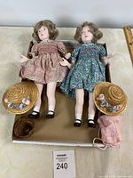 Both Nisbet dolls with hats, basket, backpack