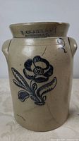 Full view of crock showing cobalt flower design, handles, cracks